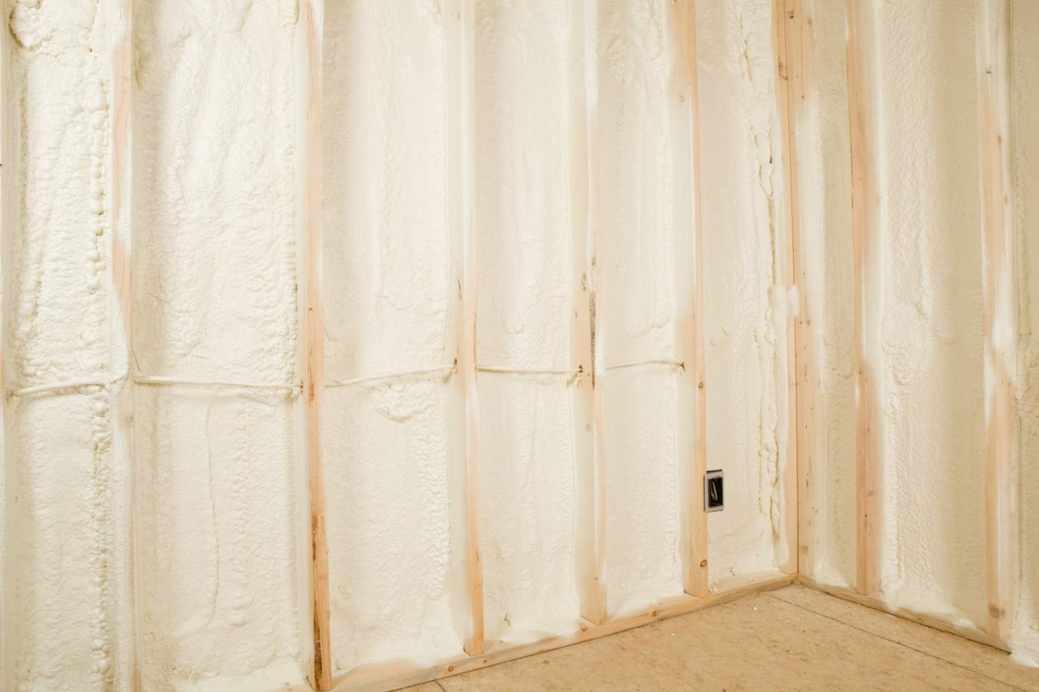 Closed-cell spray foam insulation showing thickness coverage