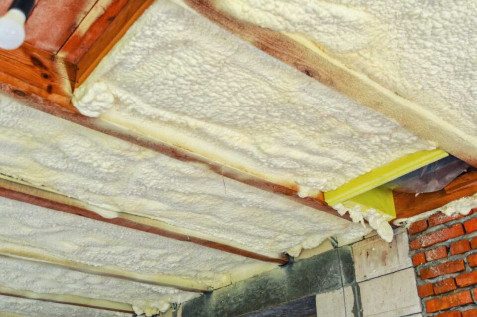 Polyurethane spray foam insulation applied to ceiling joists in Portland home for energy efficiency